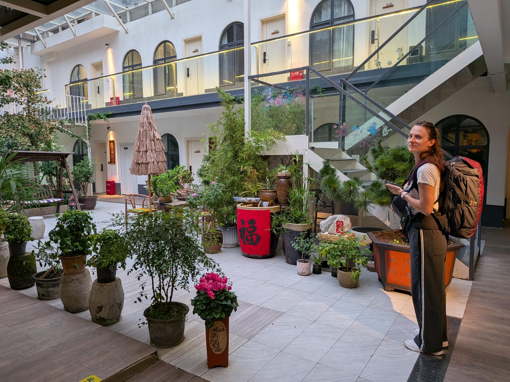 La cour de l'hôtel vue du balcon, balises de plantes et chambre 210-212 en arrière-plan